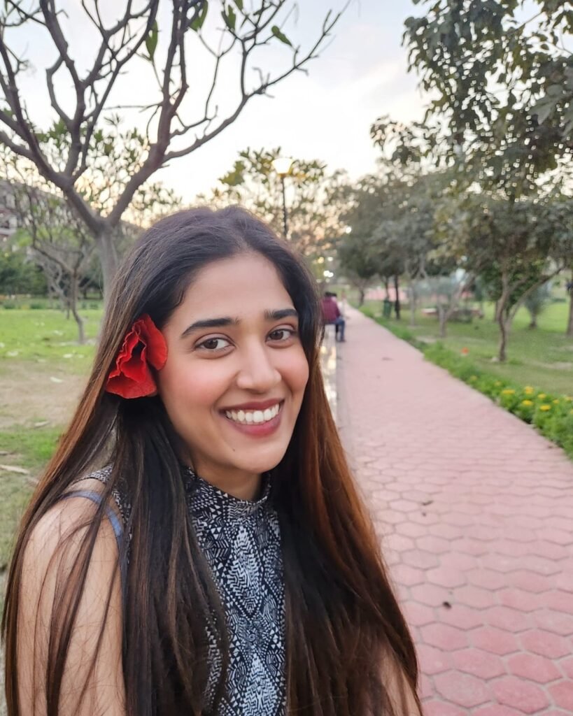 Portrait with a red flower wearing Darya jewellery