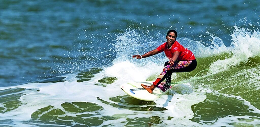 Kamali Moorthy surfing a wave at Tannirbhavi Beach in Karnataka