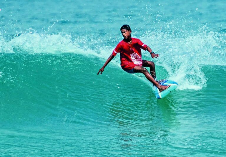 Kishore Kumar surfing a wave at Tannirbhavi Beach in Karnataka