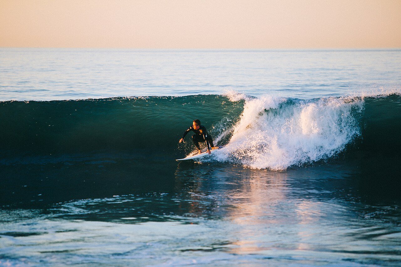 Surfer riding across the face of a wave