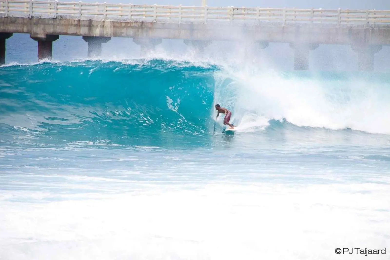 Surfer riding a wave during a Makai surf experience