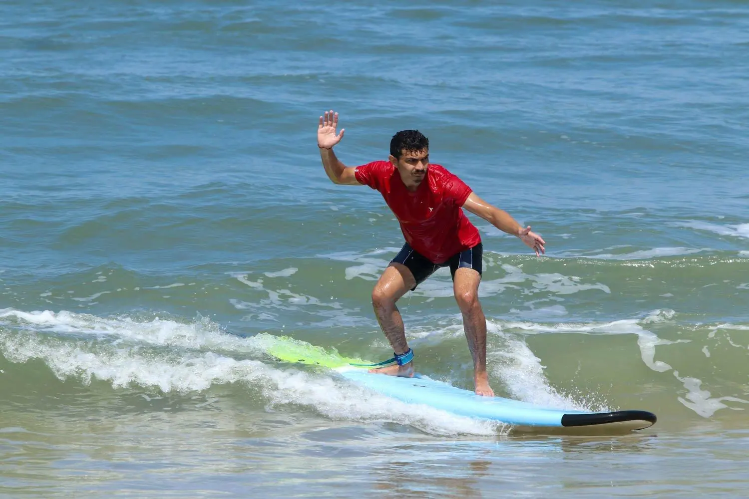 Surf student practising during a Makai surf course in Goa