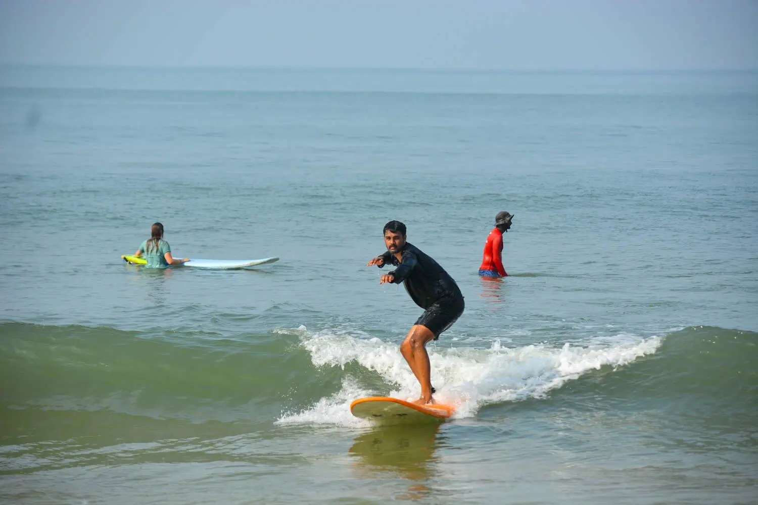 Beginner surfer learning with Makai Surf Adventure in Goa