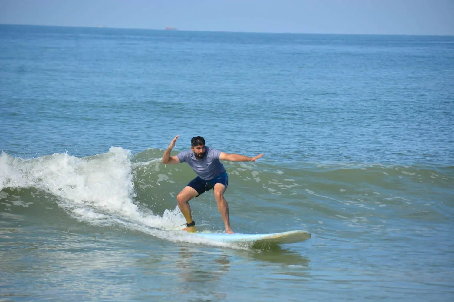 Surfer receiving coaching during a Makai surf course in Goa
