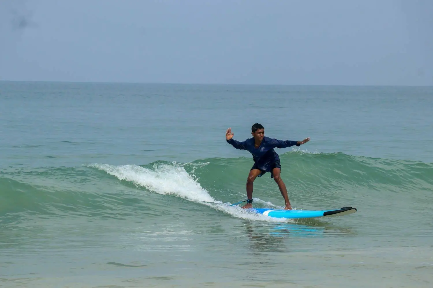 Surfer progressing through a longer Makai surf course in Goa