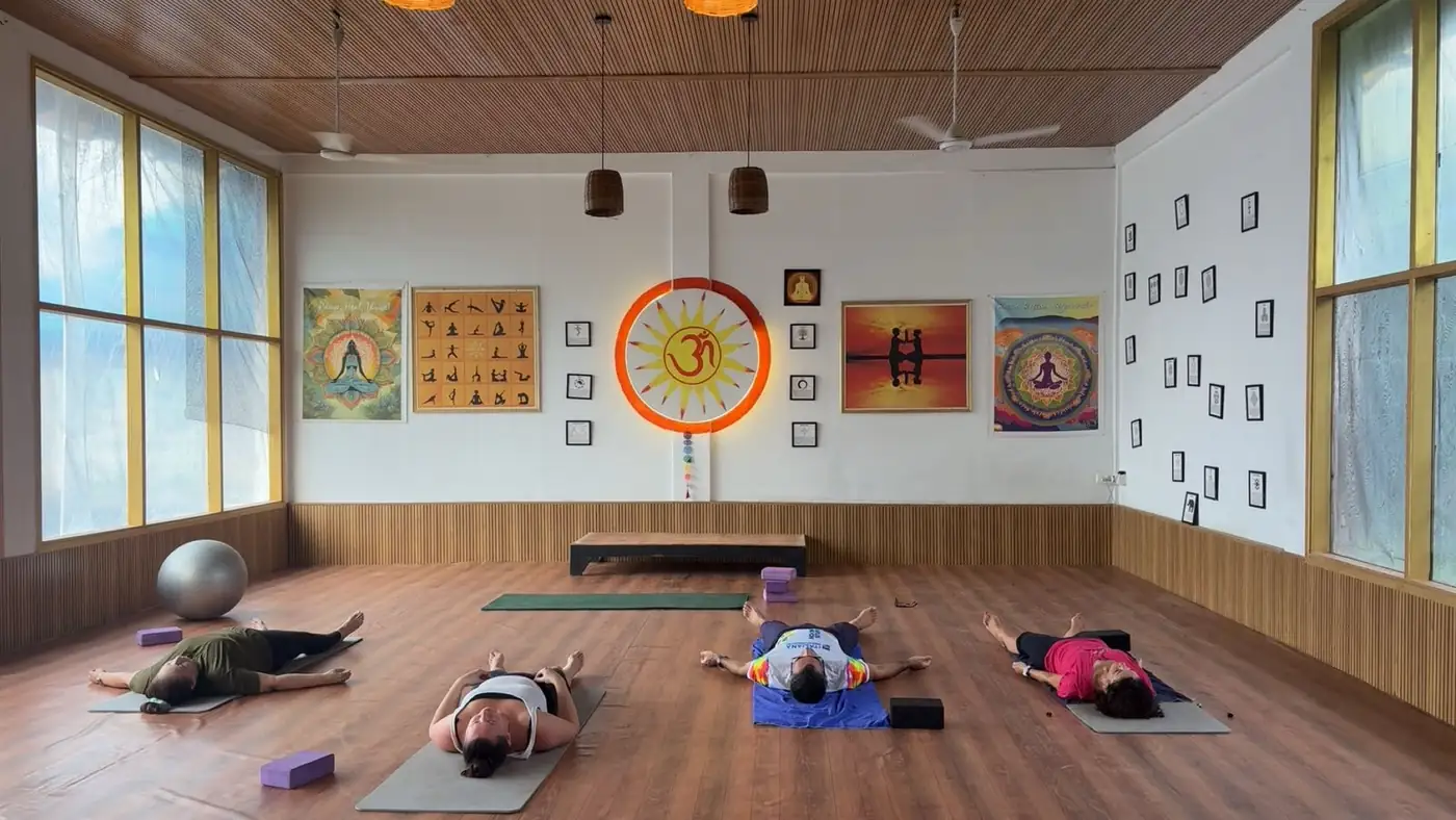 Yoga students resting during a guided session in Goa